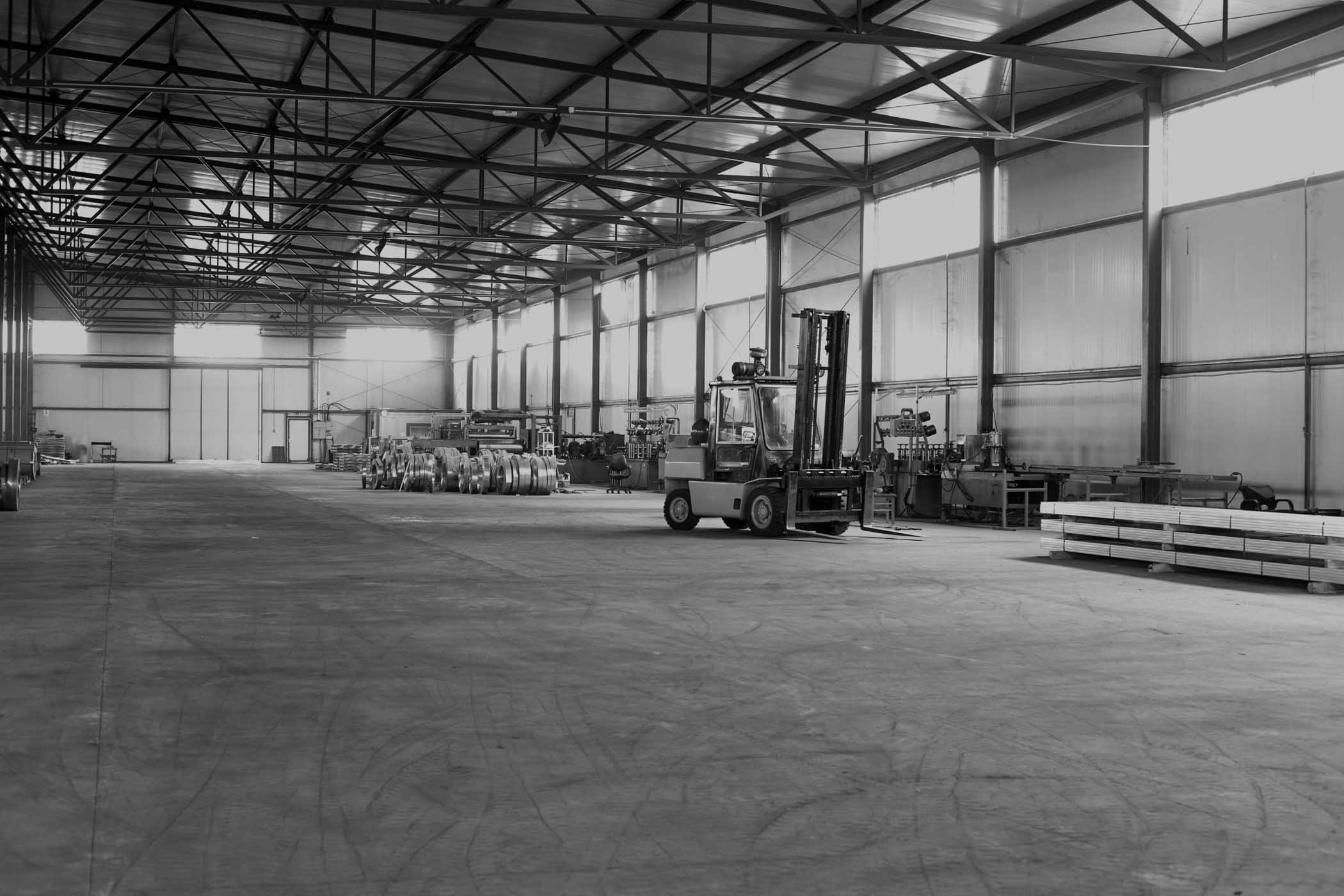 Grayscale photo of a factory plant floor