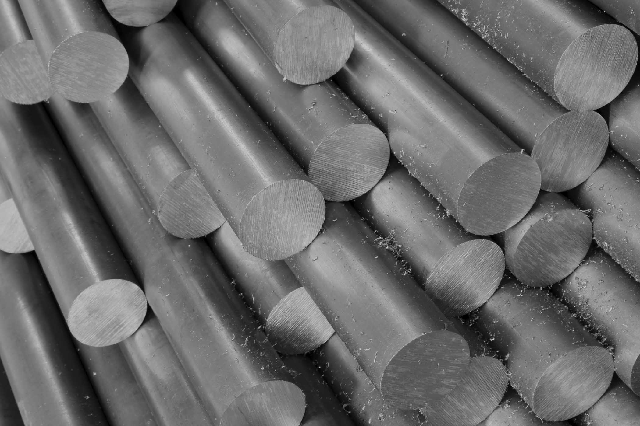 Grayscale photo of metal billets