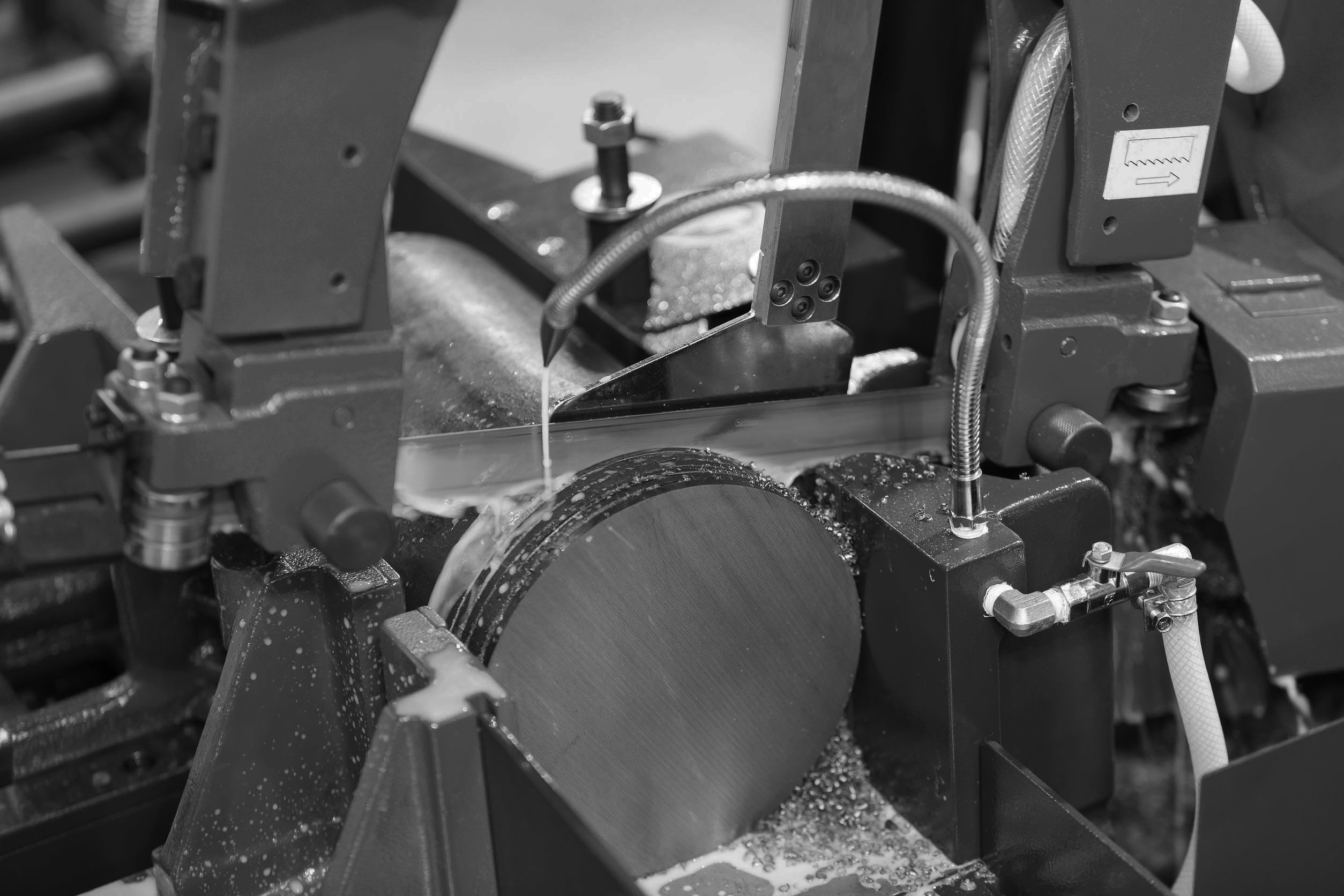 Up-close grayscale photo of a billet saw